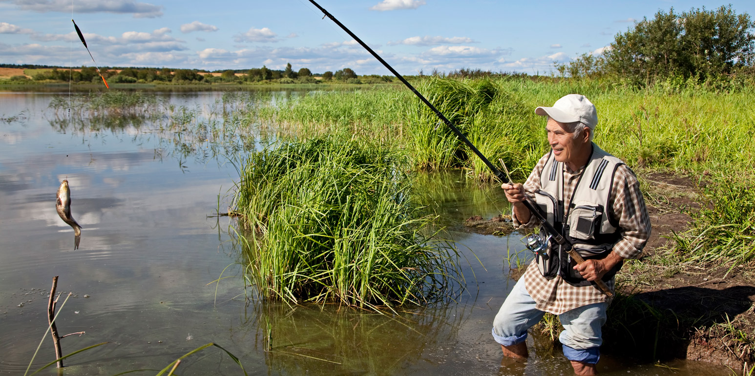 Man fly fishing on river bank